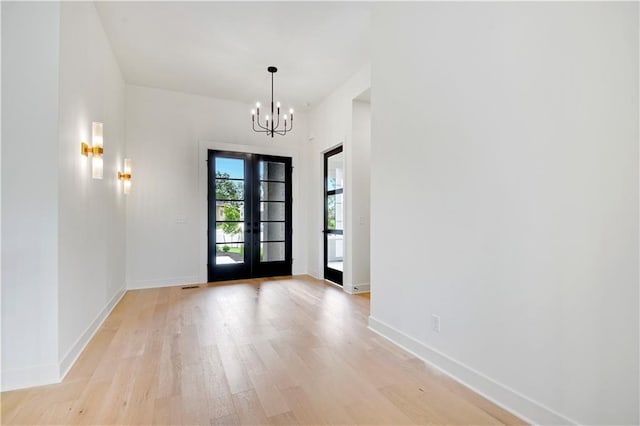 24909 W 98th Pl, Lenexa, KS 66227 - entrance foyer featuring a chandelier, light wood-type flooring, and french doors