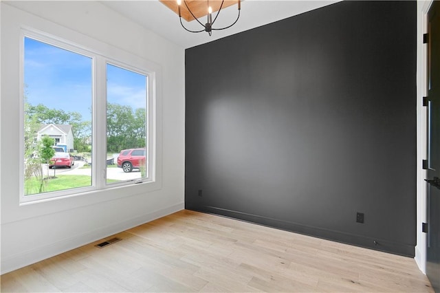 24909 W 98th Pl, Lenexa, KS 66227 - spare room with a chandelier and wood finished floors