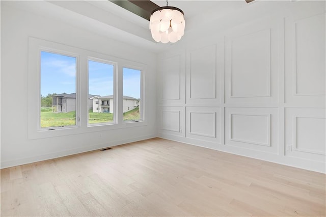 24909 W 98th Pl, Lenexa, KS 66227 - spare room featuring light wood-type flooring and a chandelier