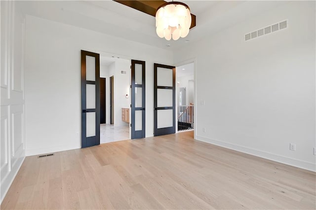 24909 W 98th Pl, Lenexa, KS 66227 - spare room featuring wood finished floors and a chandelier
