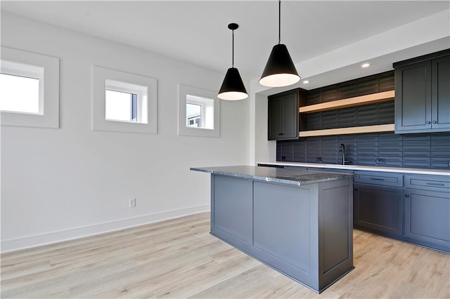 24909 W 98th Pl, Lenexa, KS 66227 - kitchen with open shelves, tasteful backsplash, a kitchen island, light wood-type flooring, and pendant lighting