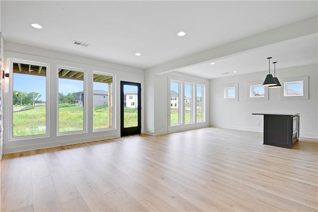 24909 W 98th Pl, Lenexa, KS 66227 - unfurnished living room with light wood-style flooring and recessed lighting