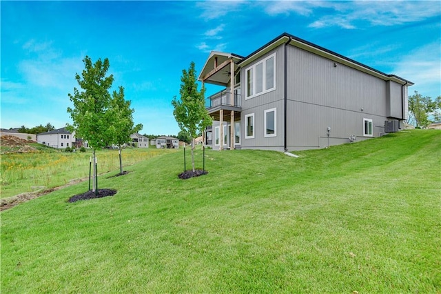 24909 W 98th Pl, Lenexa, KS 66227 - view of home's exterior with a balcony and a yard