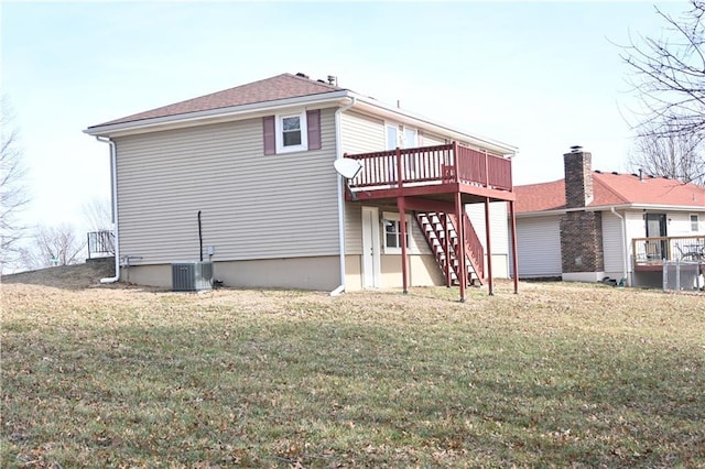 rear view of property with a deck, cooling unit, and a lawn