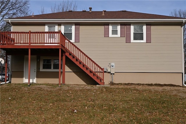 rear view of house with a lawn and a wooden deck