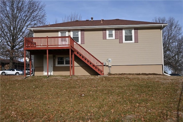 back of house featuring a lawn and a wooden deck