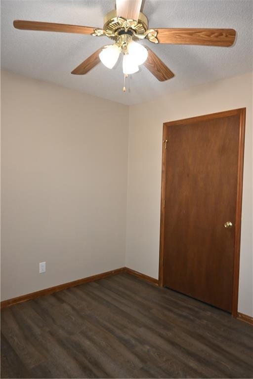 unfurnished room featuring ceiling fan, a textured ceiling, and dark hardwood / wood-style flooring