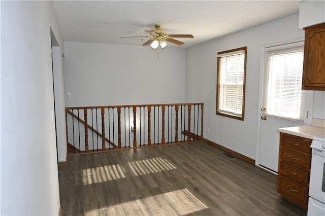 spare room featuring ceiling fan and dark hardwood / wood-style flooring