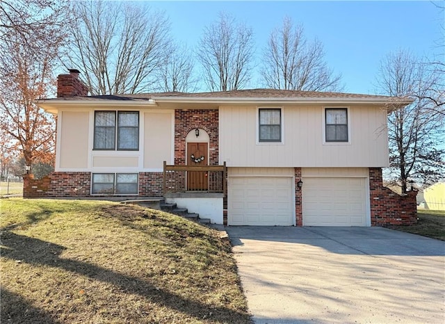 raised ranch with brick siding, driveway, and a chimney