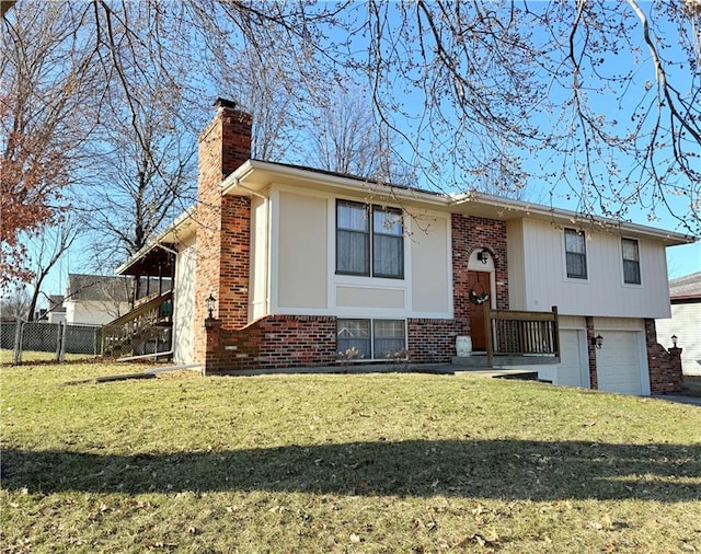 bi-level home featuring a front yard, fence, a chimney, a garage, and brick siding