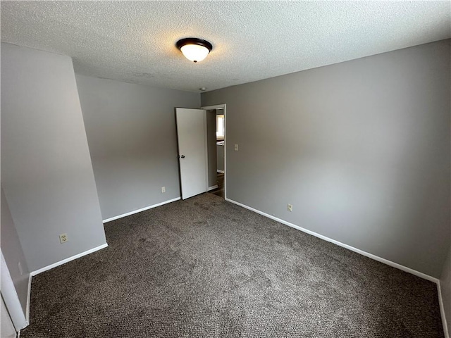 carpeted spare room with a textured ceiling