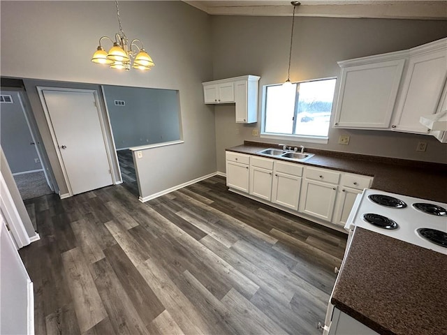 kitchen featuring pendant lighting, dark hardwood / wood-style floors, sink, and white cabinets