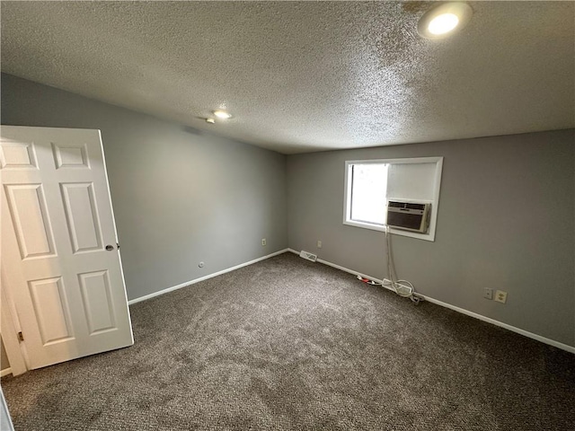 interior space with cooling unit, dark carpet, and a textured ceiling