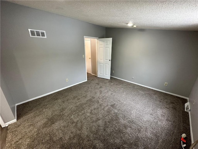 carpeted spare room with a textured ceiling