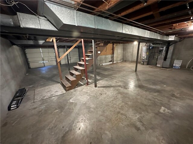 basement featuring gas water heater and heating unit