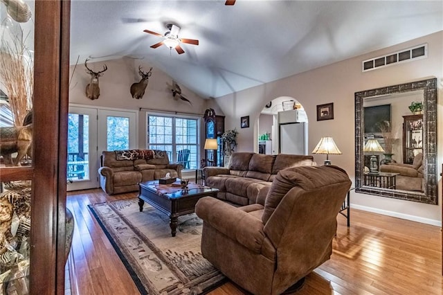 living room featuring ceiling fan, lofted ceiling, and hardwood / wood-style floors