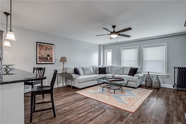 living room featuring dark hardwood / wood-style floors and ceiling fan