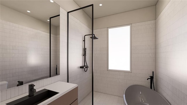 bathroom with vanity, a freestanding tub, tile walls, recessed lighting, and walk in shower