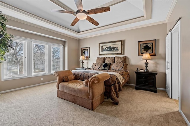 bedroom featuring light carpet, a tray ceiling, and crown molding