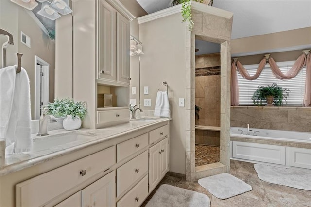 bathroom with visible vents, a sink, a bath, and tiled shower