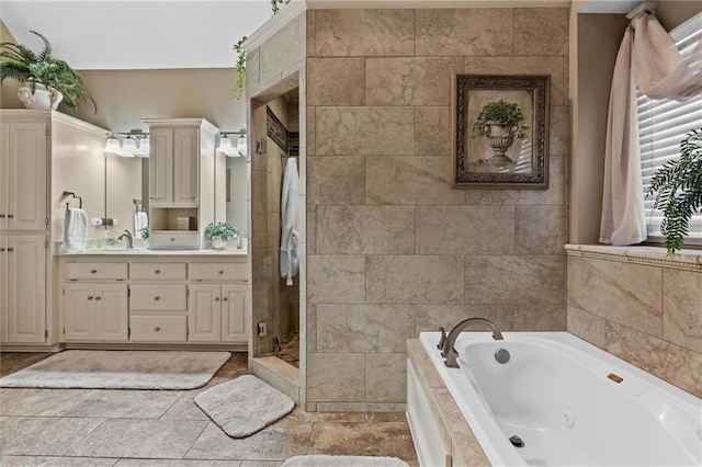 full bath featuring a whirlpool tub, a stall shower, and vanity