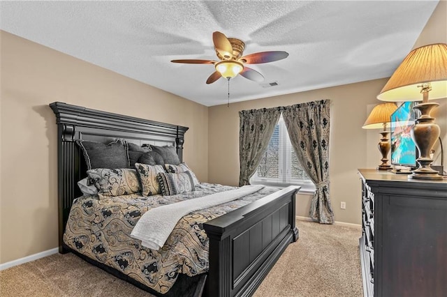 bedroom featuring baseboards, a textured ceiling, visible vents, and light colored carpet