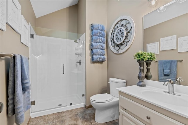 bathroom with lofted ceiling, toilet, vanity, and a shower stall