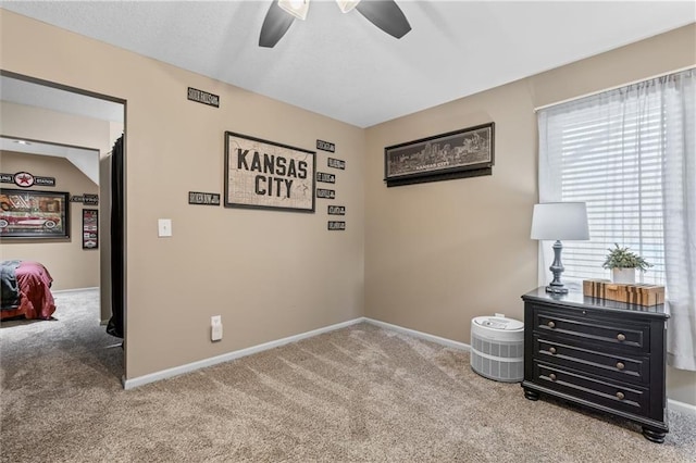 bedroom with light colored carpet, ceiling fan, and baseboards