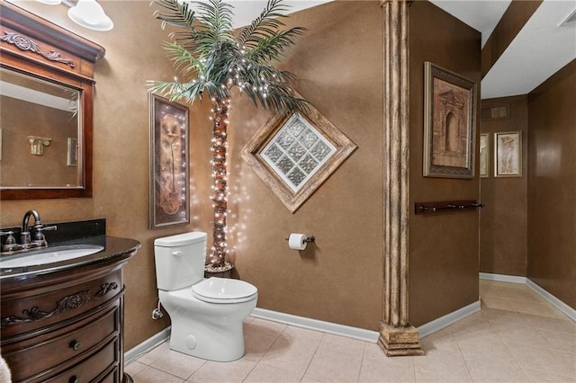 bathroom featuring visible vents, toilet, vanity, baseboards, and tile patterned floors