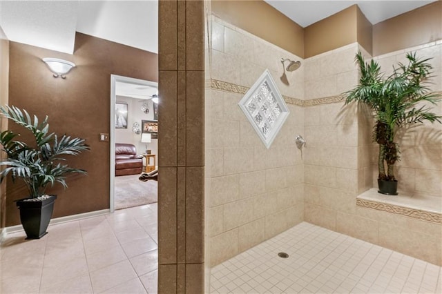 full bath with a tile shower and tile patterned floors