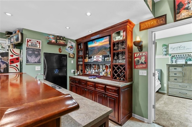 bar with a dry bar, light colored carpet, freestanding refrigerator, a sink, and recessed lighting