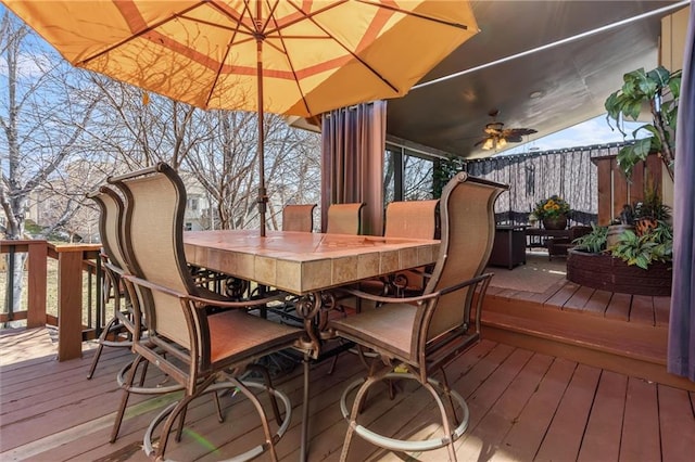 wooden deck with outdoor dry bar and ceiling fan