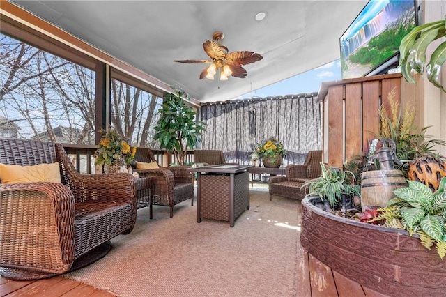 sunroom / solarium with lofted ceiling and a ceiling fan