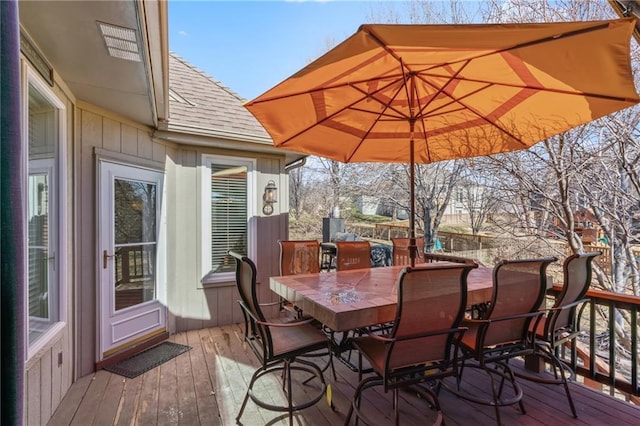 wooden terrace with outdoor dining space