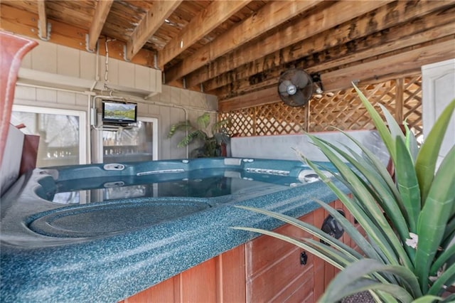 view of swimming pool with an indoor hot tub