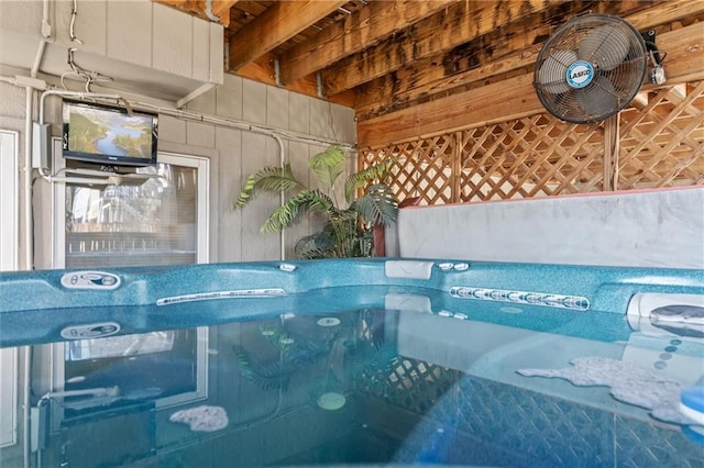 view of swimming pool featuring a hot tub