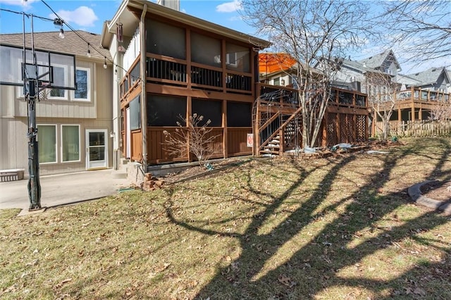 rear view of house with fence, a patio, stairway, and a lawn