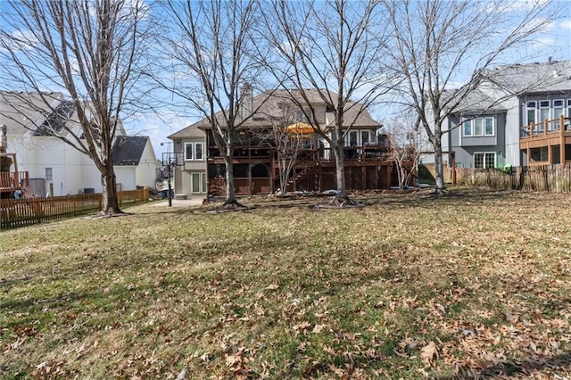 view of yard featuring a residential view, fence, and a deck