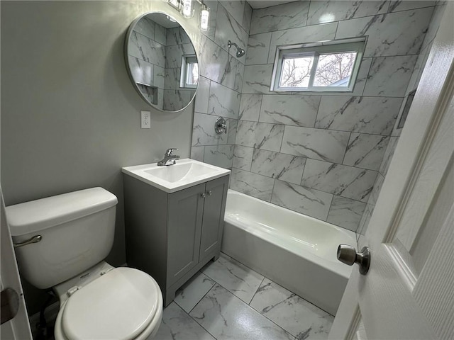 full bathroom with vanity, tiled shower / bath combo, and toilet