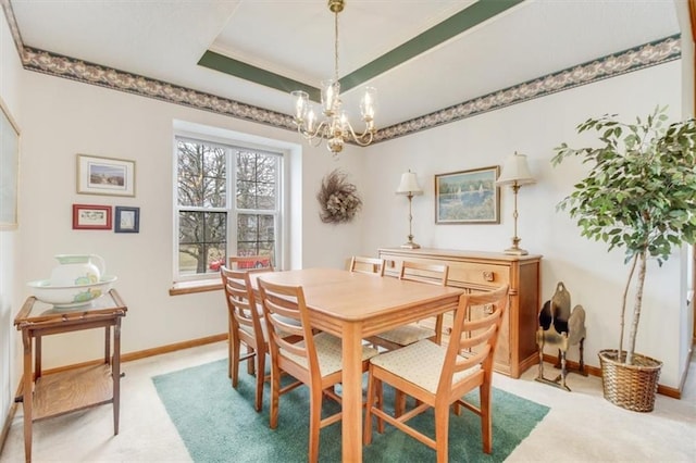 carpeted dining area with a raised ceiling and a chandelier