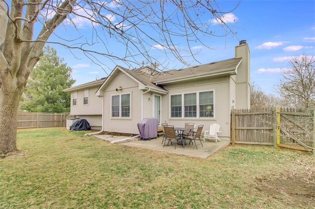 back of house featuring a patio and a yard