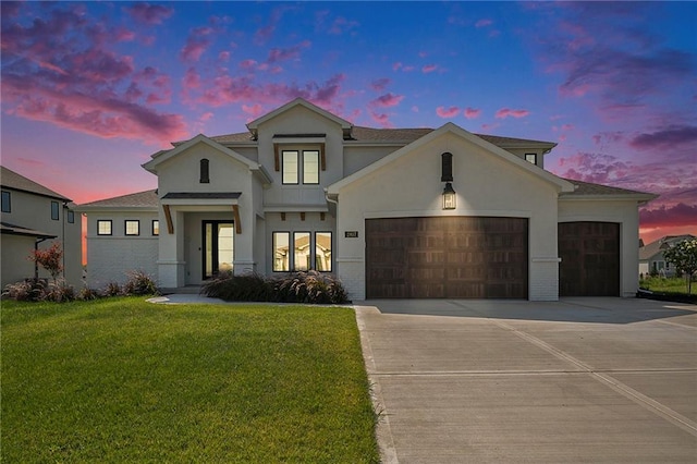 view of front facade featuring a garage and a lawn