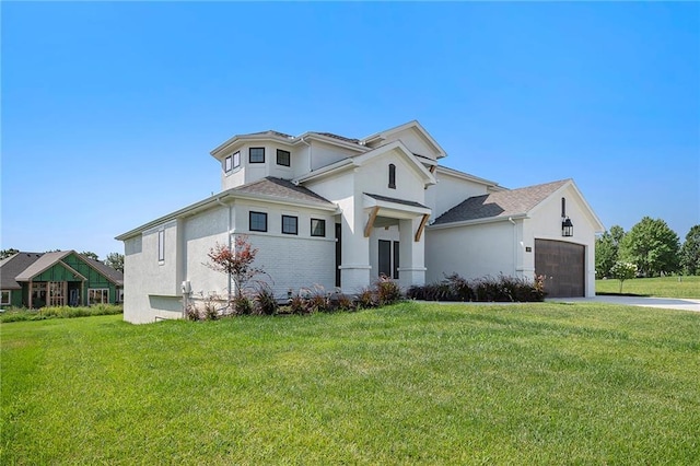 view of front of home with a garage and a front lawn