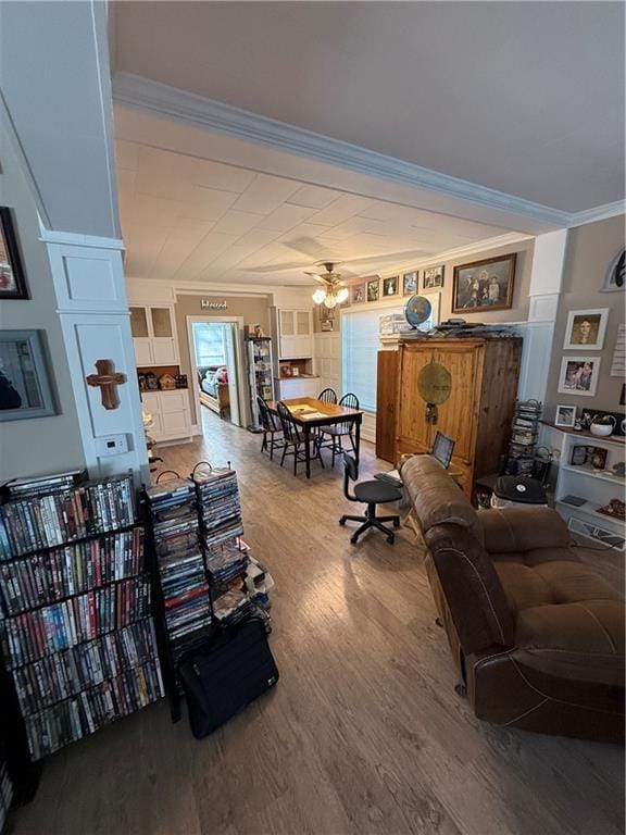 living room with ornamental molding, hardwood / wood-style floors, and ceiling fan