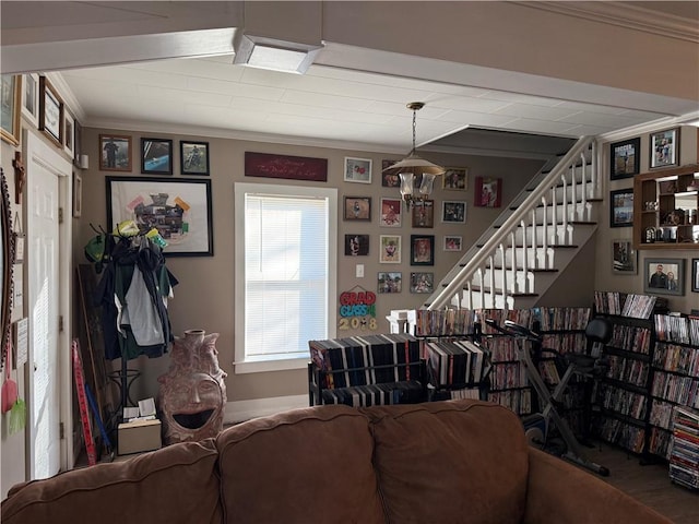 living room with hardwood / wood-style flooring, ornamental molding, and a chandelier