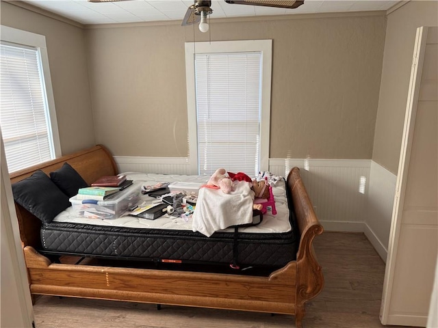 bedroom with hardwood / wood-style floors and ceiling fan