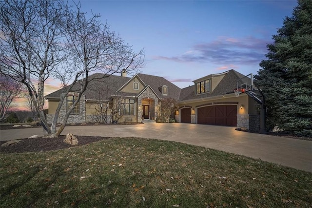 view of front facade featuring stucco siding, concrete driveway, a garage, stone siding, and a lawn