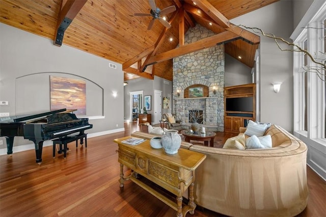 living room featuring a stone fireplace, wooden ceiling, wood finished floors, and beam ceiling