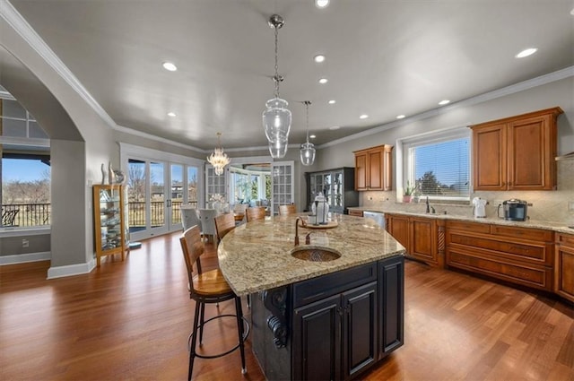 kitchen featuring tasteful backsplash, a sink, a wealth of natural light, and wood finished floors