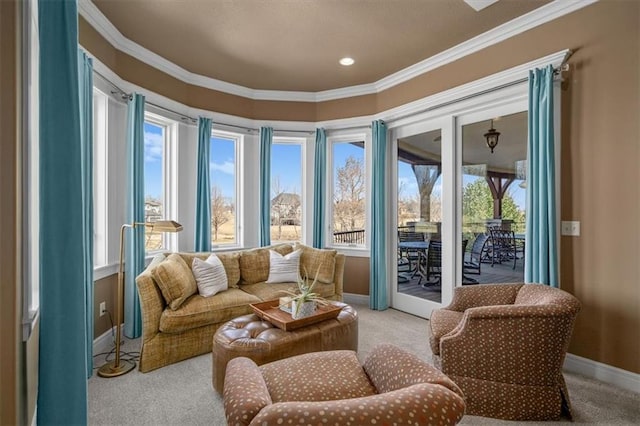 living area with light carpet, crown molding, and baseboards